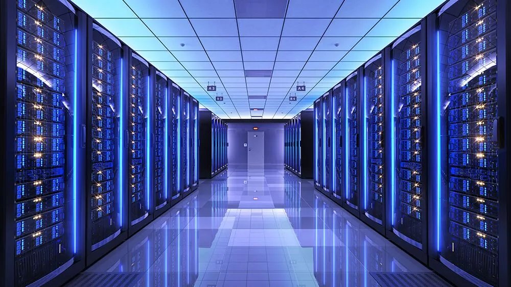Operating data center hall with rows of blue-lit server racks