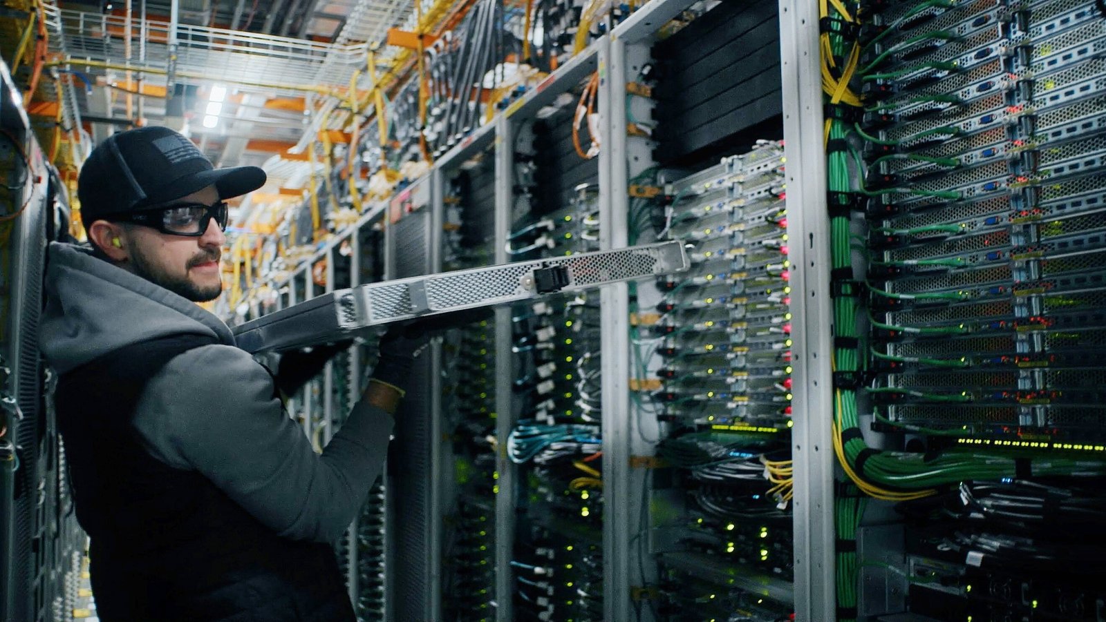 Data center technician working on cabling and equipment during commissioning